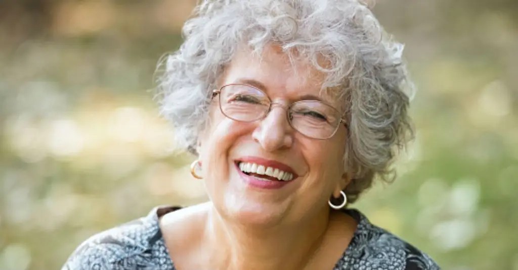 Garden-Ready Gray Curls, Short and Bouncy — short hairstyle for coarse gray hair on a woman over 70