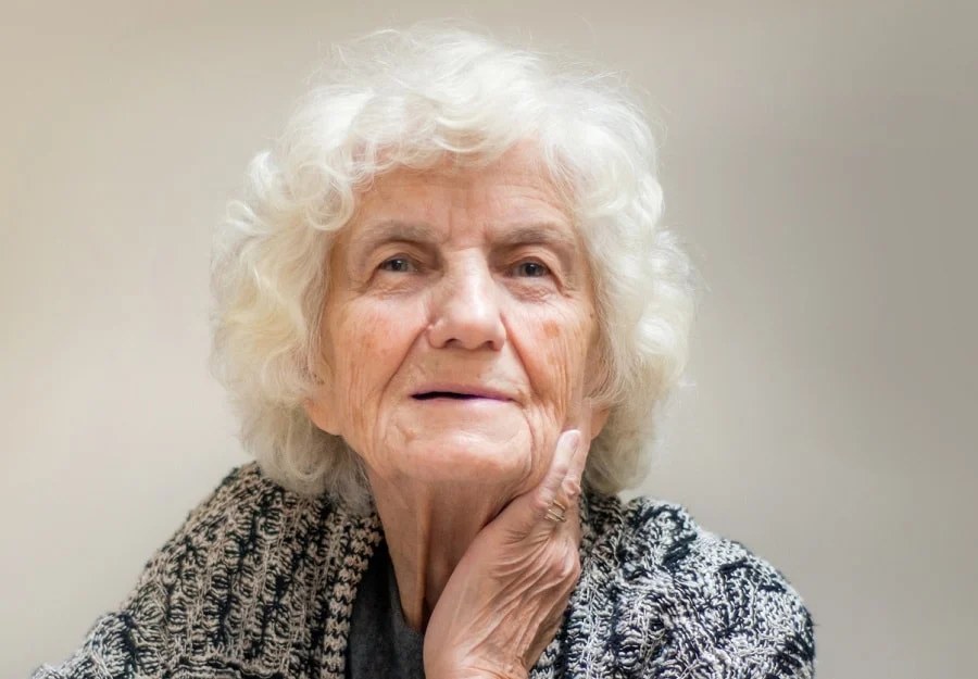 The Gentle White Curly Cloud — short curly haircut on a woman over 70, easy to care for