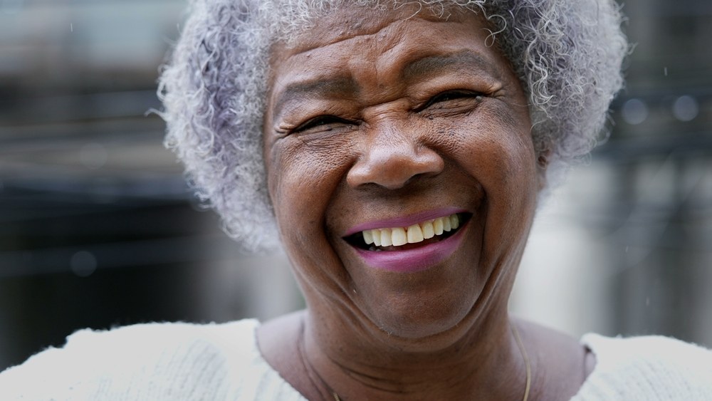 The Joyful Short Gray Afro — short curly haircut on a woman over 70, easy to care for