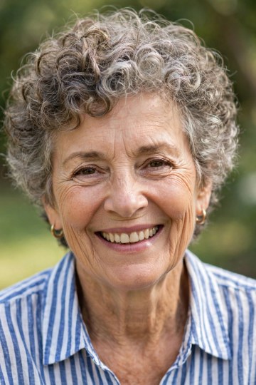 Short Defined Gray Curls, Outdoors — short curly haircut on a woman over 70, easy to care for