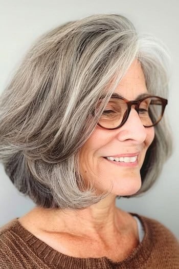 Woman over 70 with a layered bob worn with glasses — short easy haircut for women over 70