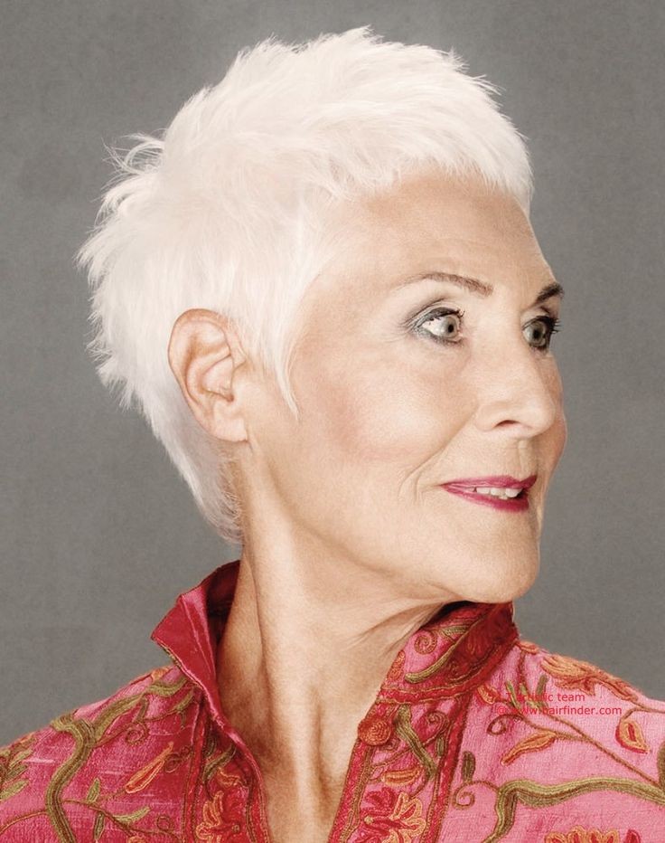 Woman over 70 with a bright white tapered pixie — short easy haircut for women over 70