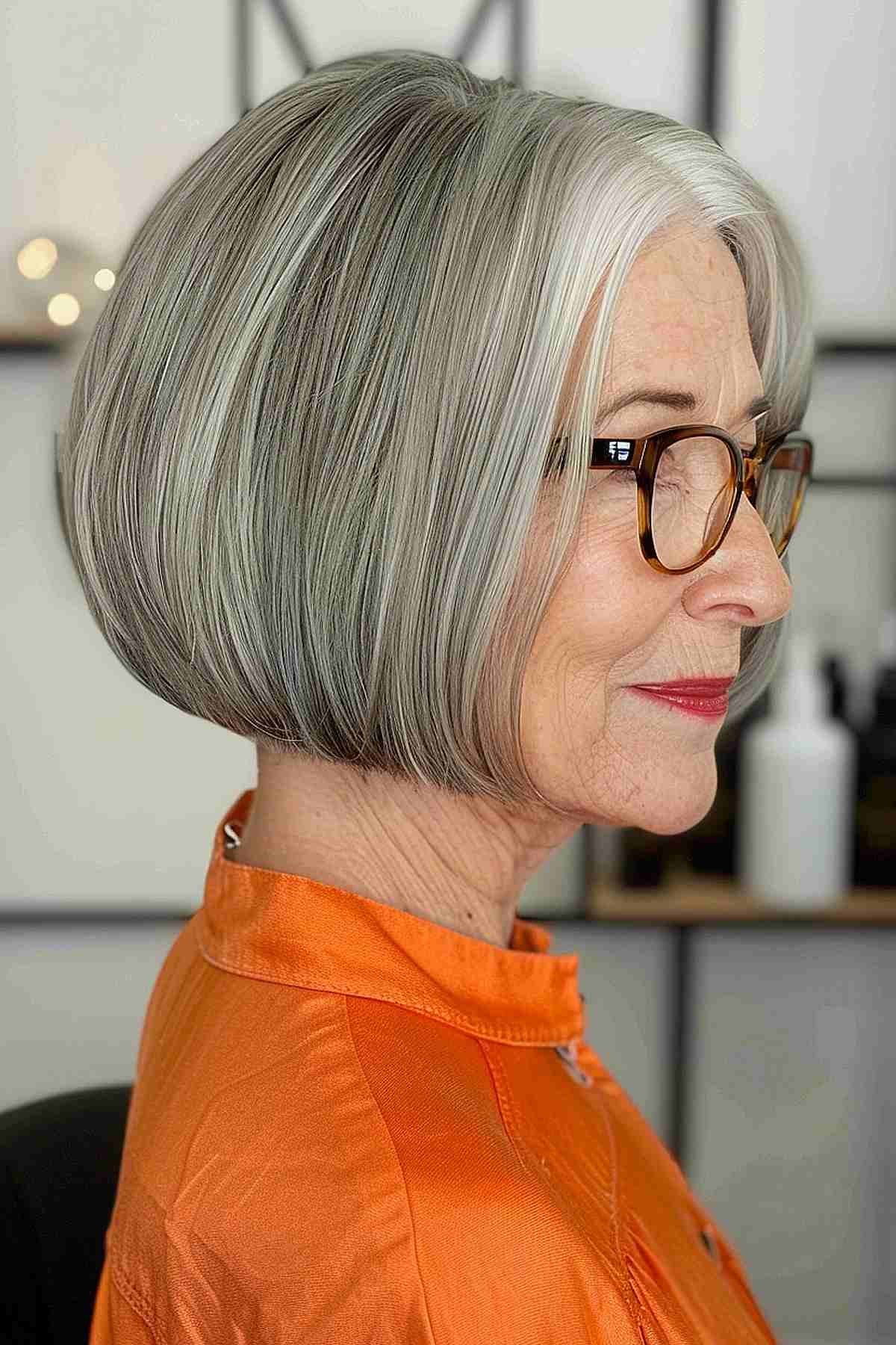 Woman over 70 with a sleek graduated bob in profile — short easy haircut for women over 70