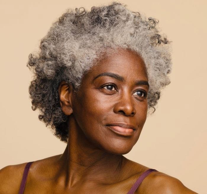The Light Gray Curly Crop — short gray natural haircut on a Black woman over 70