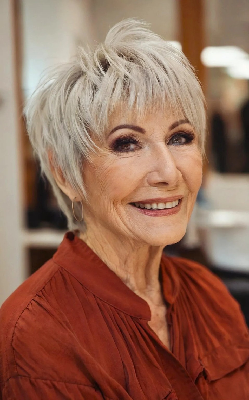 Woman over 70 with spiky textured pixie with a light fringe — flattering bangs hairstyle for women over 70