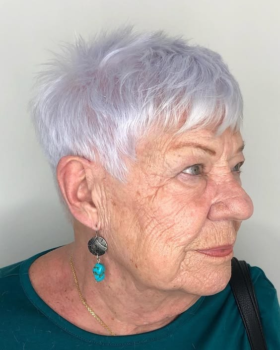 Woman over 70 with short white pixie with a neat fringe — flattering bangs hairstyle for women over 70