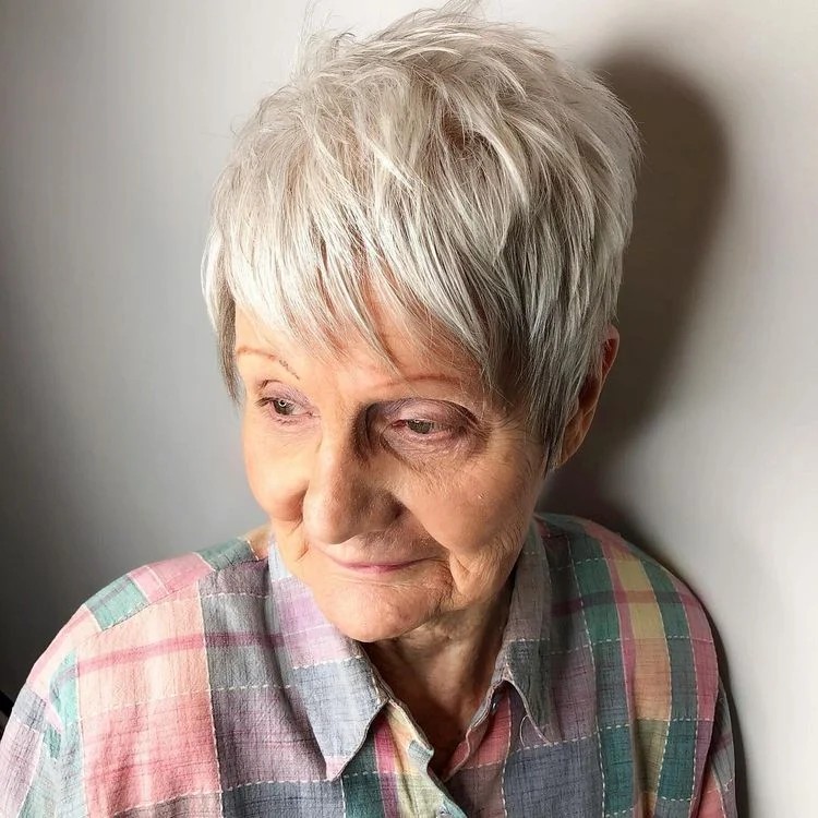 Woman over 70 with soft pixie with wispy, feathered bangs — flattering bangs hairstyle for women over 70