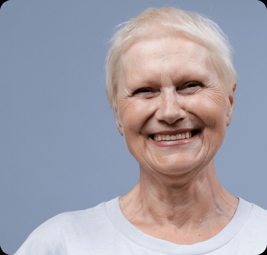 The Soft Blonde Crop With a Rounded Silhouette — short haircut on a woman over 70 with a soft jawline