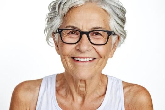 woman over 70 with a short wavy gray crop wearing black glasses
