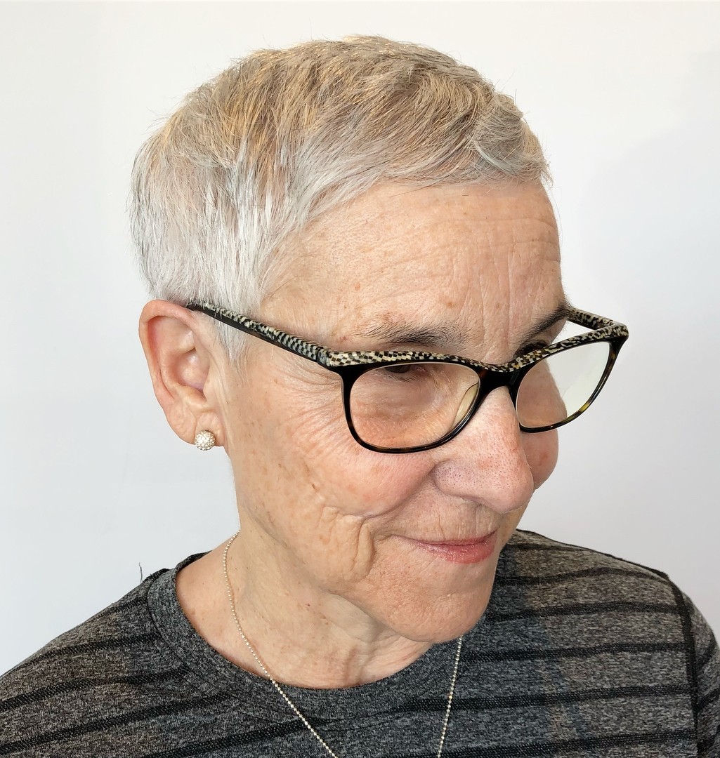 woman over 70 with an easy short crop wearing patterned glasses