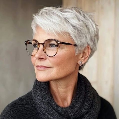 woman over 70 with a feathered white pixie cut wearing tortoiseshell glasses