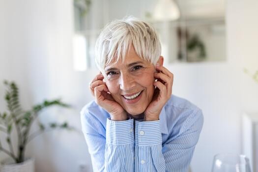 Woman over 70 with a soft blonde pixie with bangs — short hairstyle for women over 70