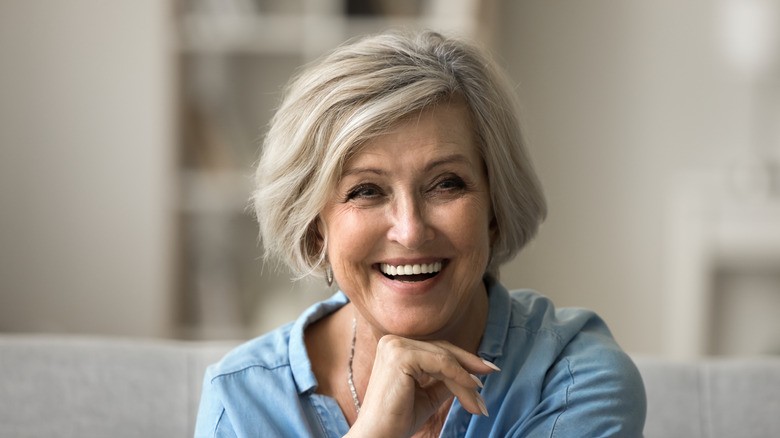Woman over 70 with a rounded beige-blend bob — short hairstyle for women over 70