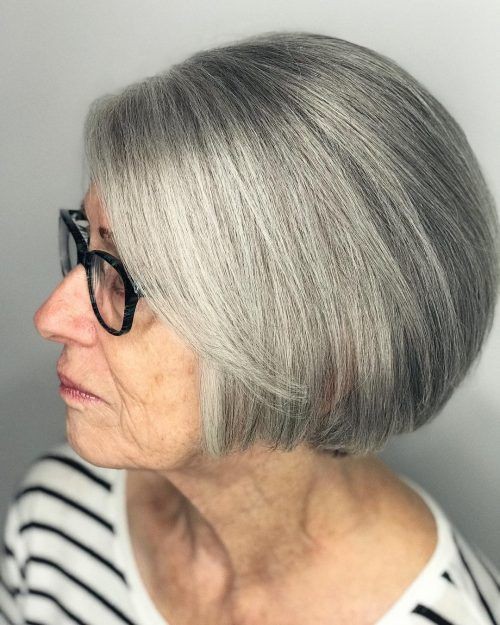 Woman over 70 with a sleek silver bob with glasses — short layered haircut back view for women over 70