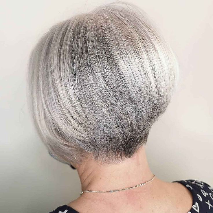 Woman over 70 with a graduated silver bob — short layered haircut back view for women over 70