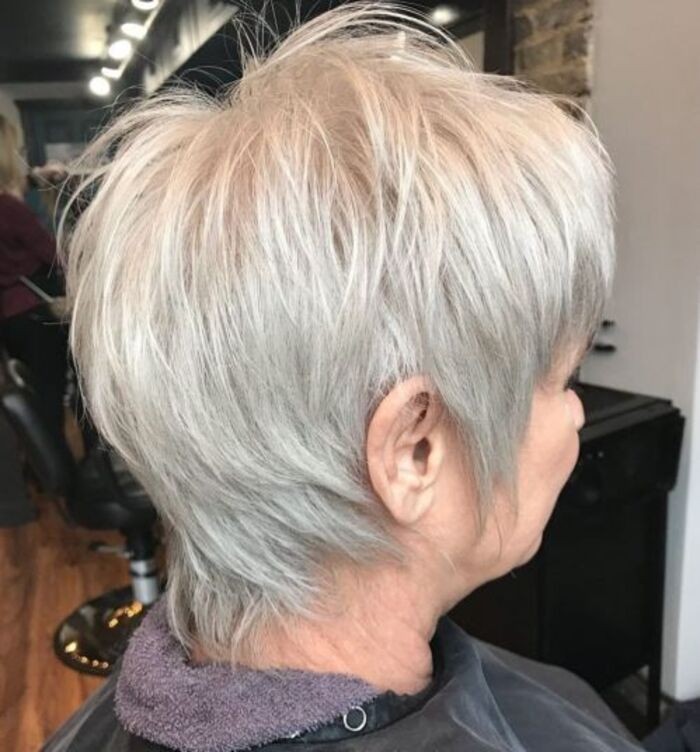 Woman over 70 with a long white shag layers — short layered haircut back view for women over 70