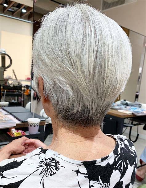 Woman over 70 with a classic silver taper — short layered haircut back view for women over 70
