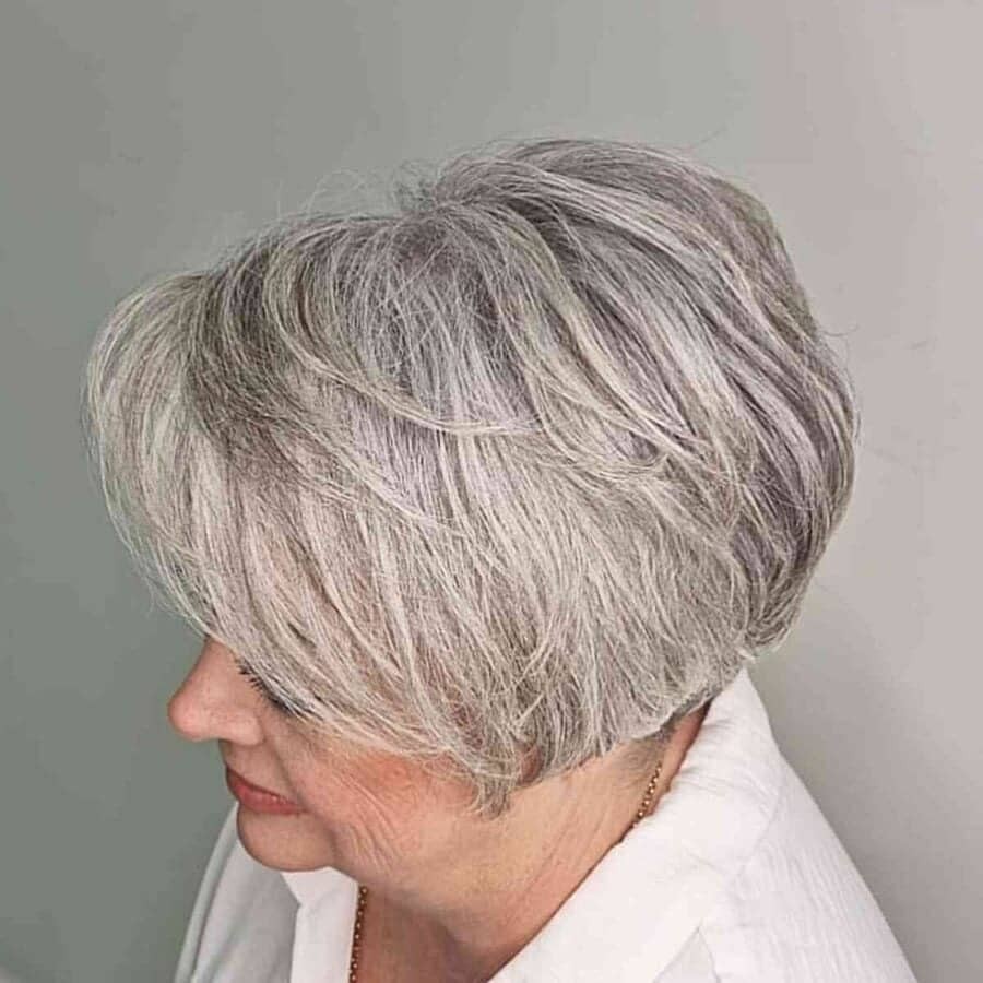 Woman over 70 with a long layered pixie-bob — side and back view — short layered haircut back view for women over 70