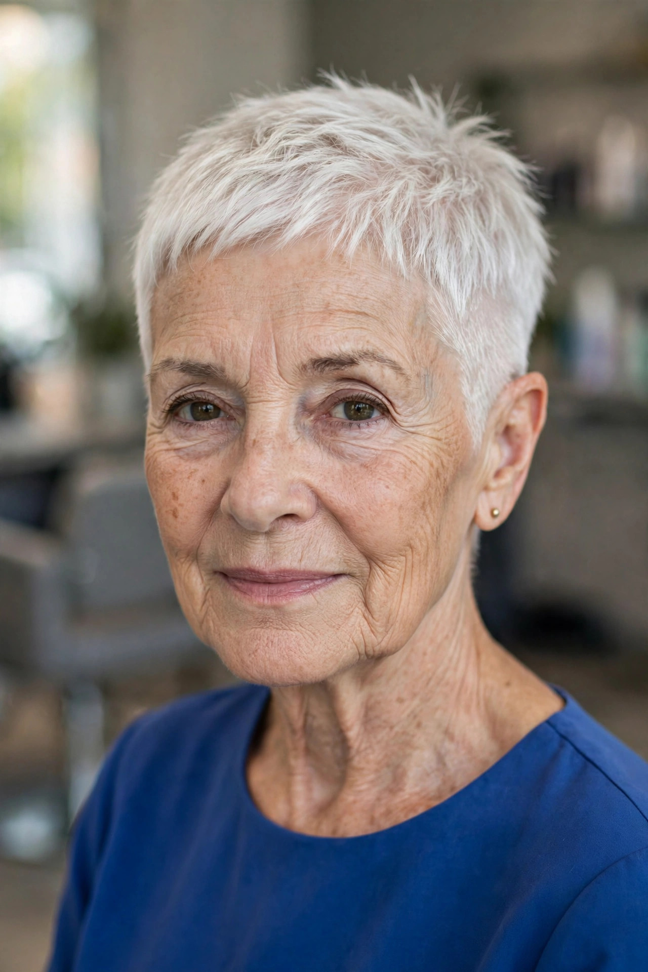 super short cropped pixie haircut with faded sides in platinum white hair on a woman over 60