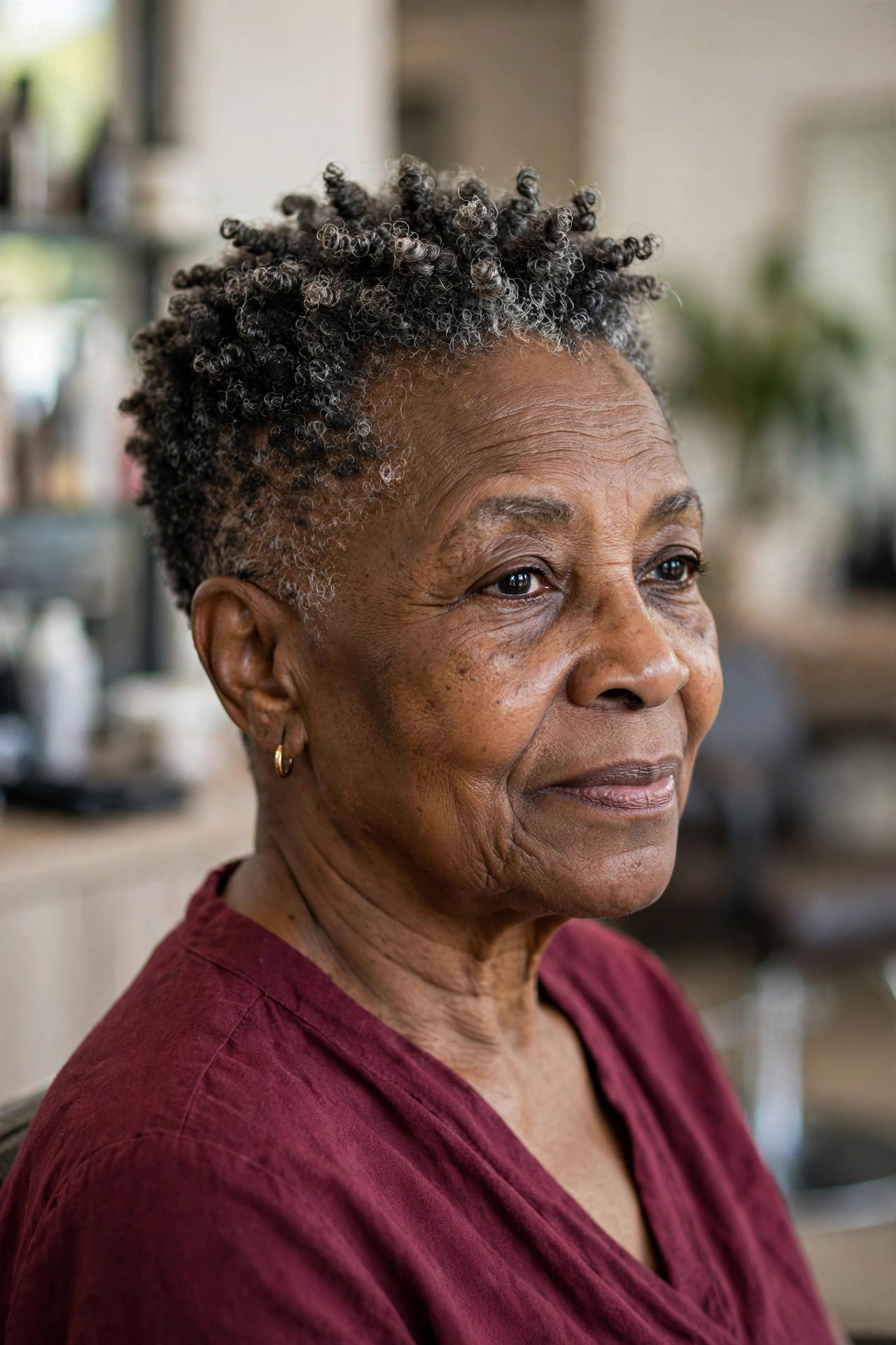 Salt-and-Pepper Tapered Coils - short tapered natural haircut on a Black woman over 60