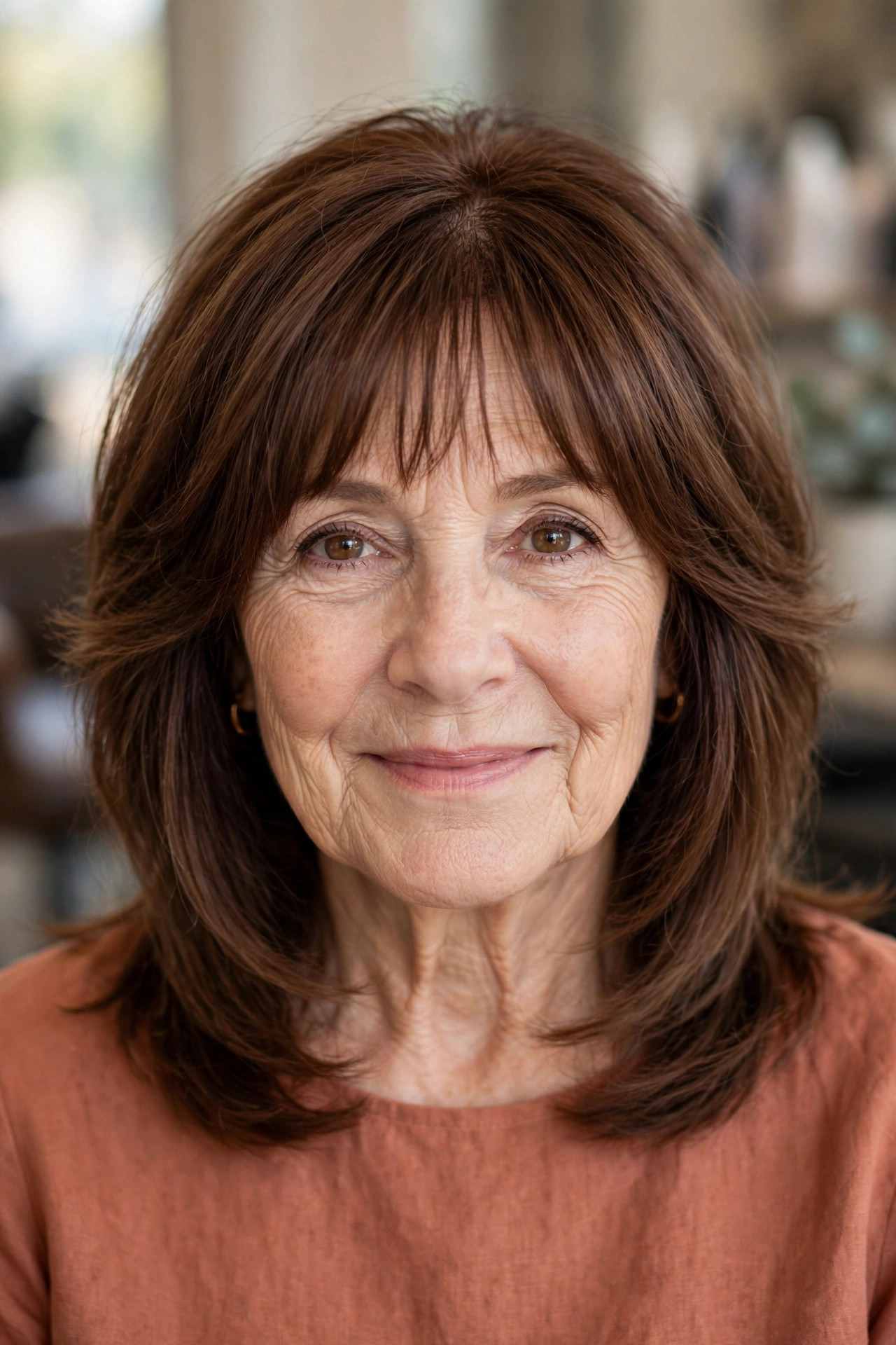 Layered Cut with Bottleneck Bangs in Cocoa Brown - shoulder length layered haircut on a woman over 50