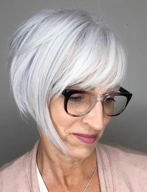 Woman over 70 with angled bob with a long side fringe and glasses — flattering bangs hairstyle for women over 70