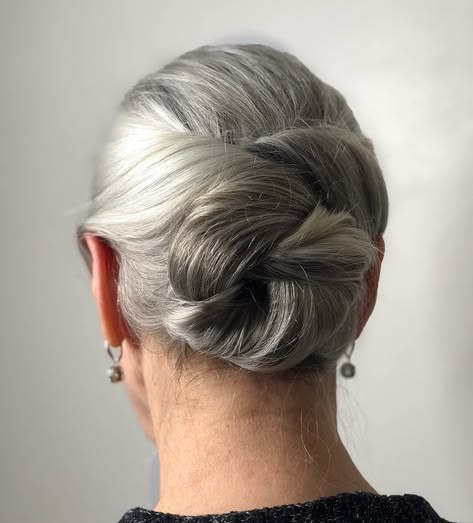 Woman over 70 with figure-Eight Infinity Bun — simple bun hairstyle for long gray hair inspiration for women over 70
