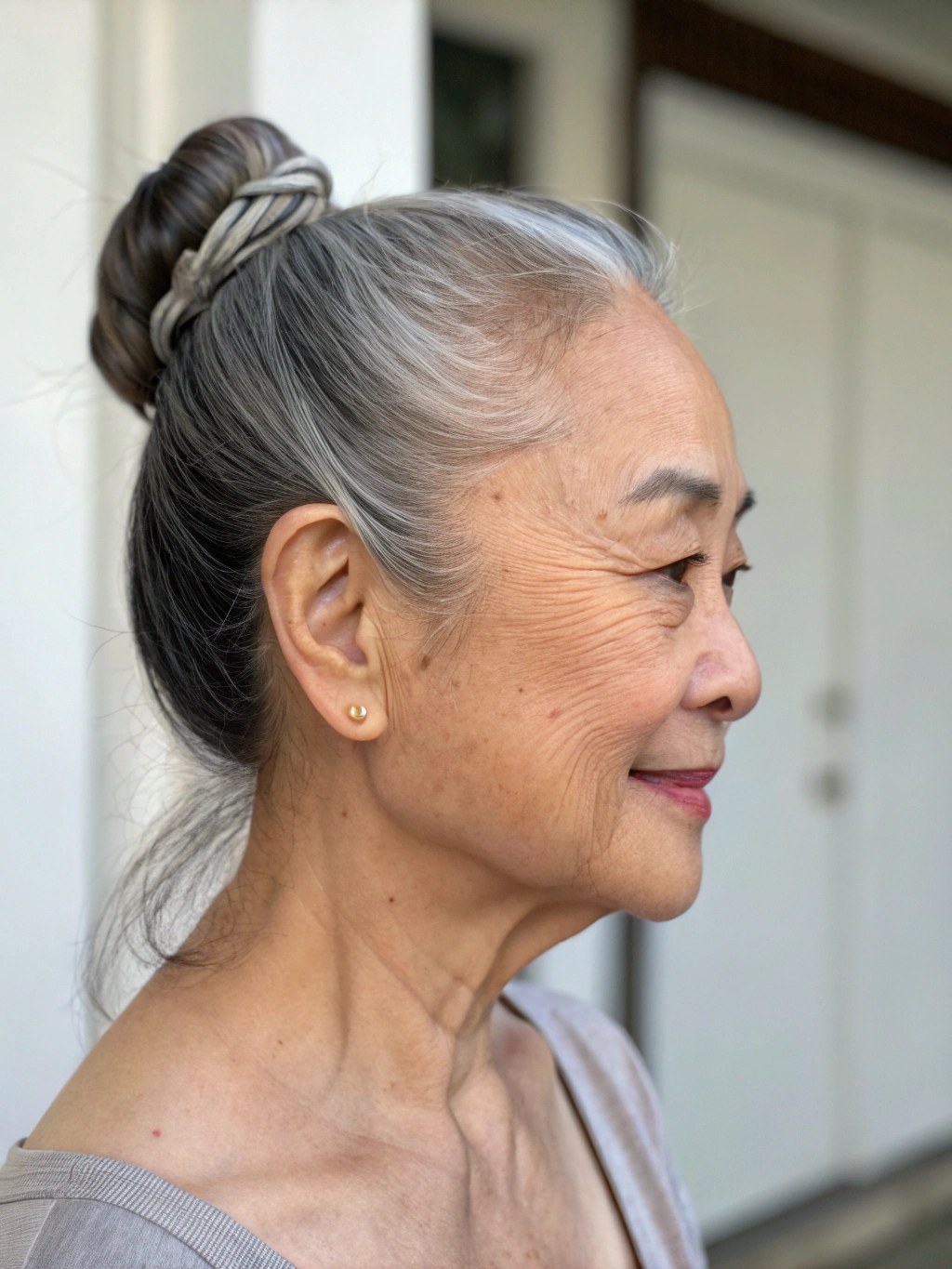 Woman over 70 with wrapped Ponytail Bun — simple bun hairstyle for long gray hair inspiration for women over 70