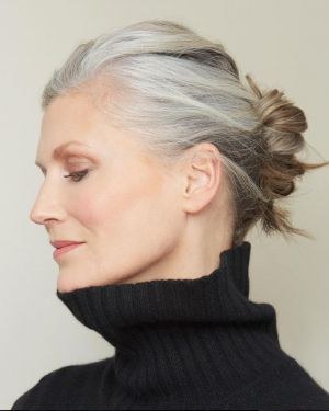 Woman over 70 with easy Claw-Clip Bun — simple bun hairstyle for long gray hair inspiration for women over 70