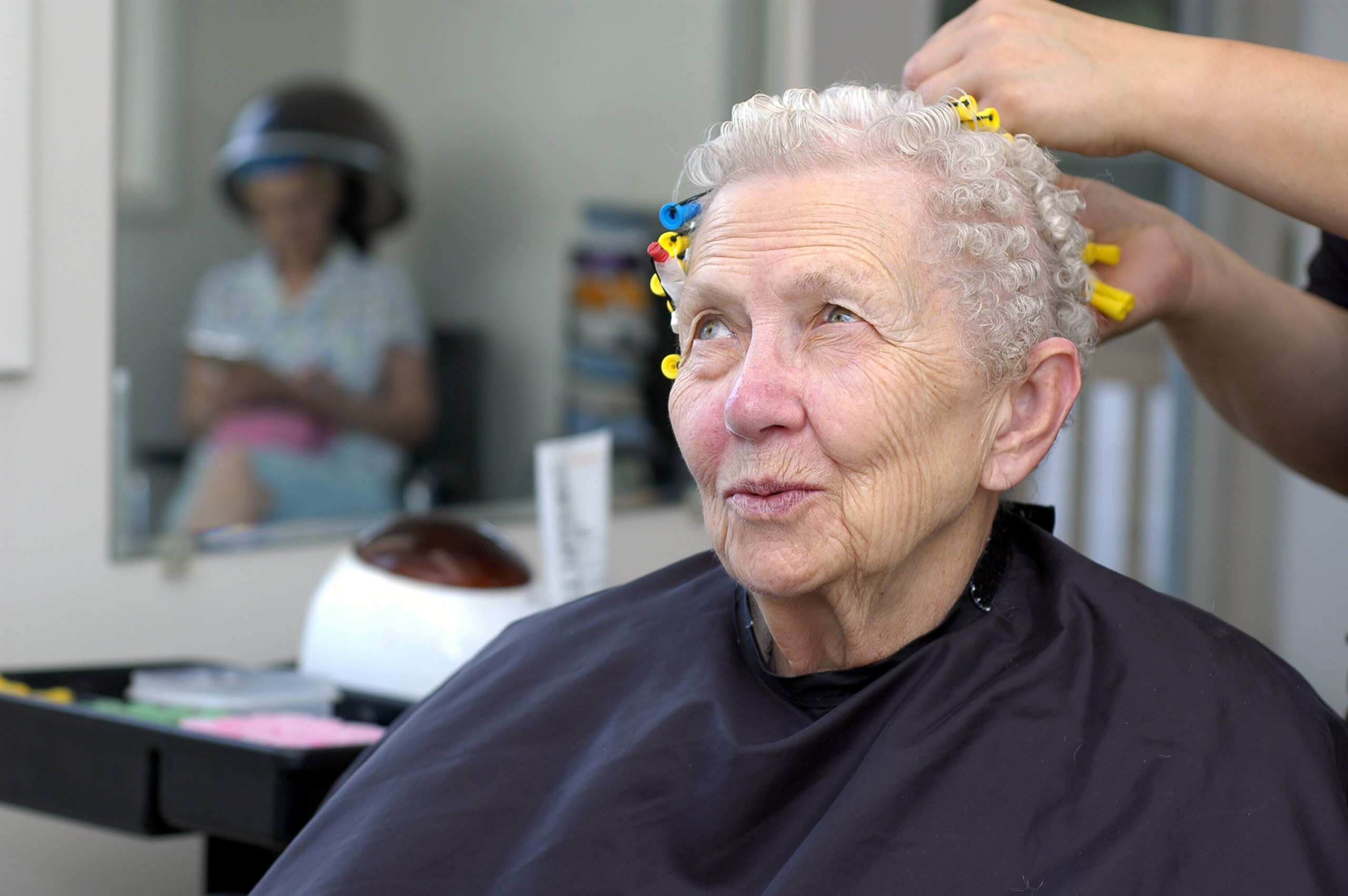 In the Chair: Rods In, Patience On — soft perm curls on a woman over 70 with flat hair