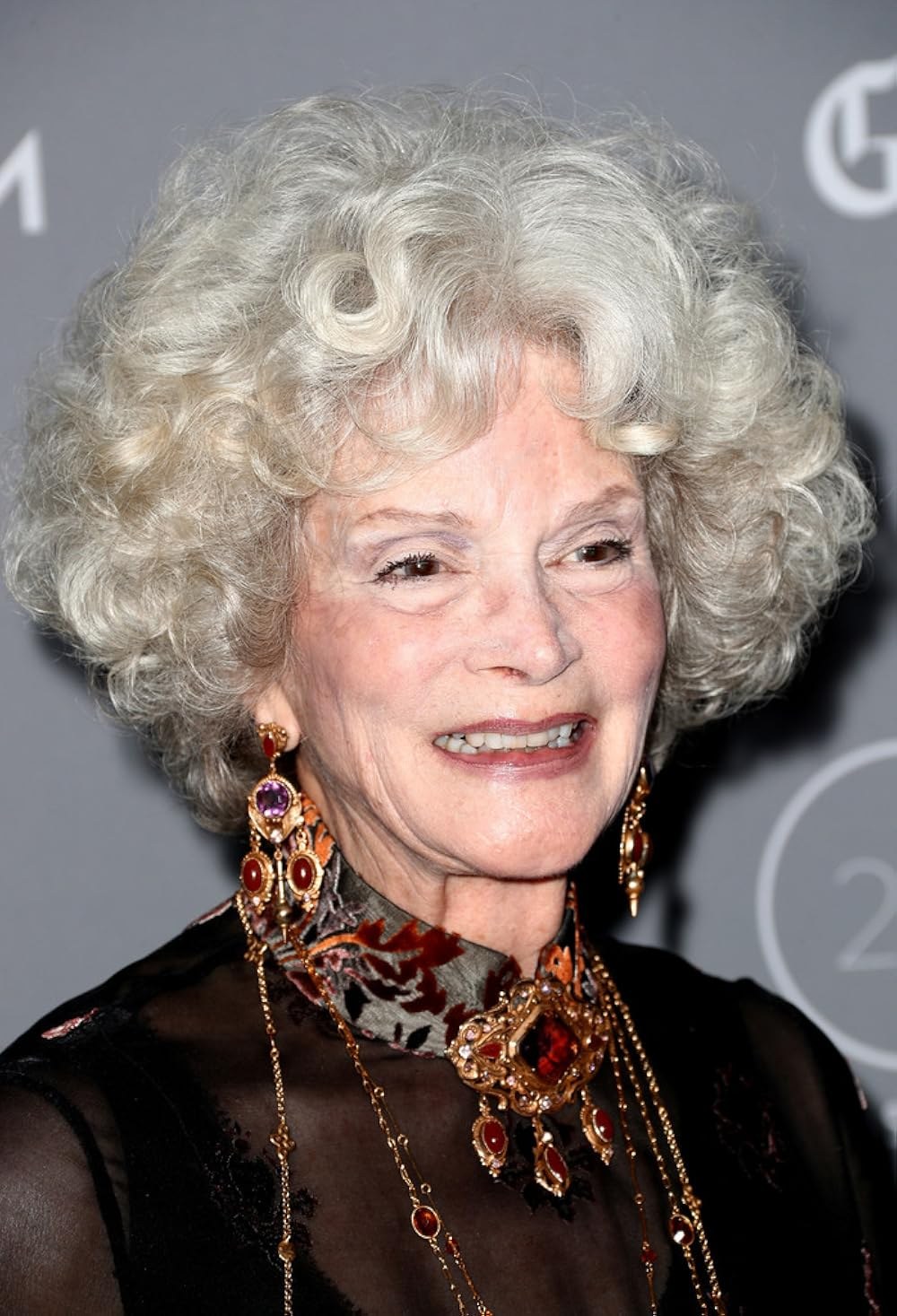 The Celebration Curls With Statement Earrings — soft perm curls on a woman over 70 with flat hair