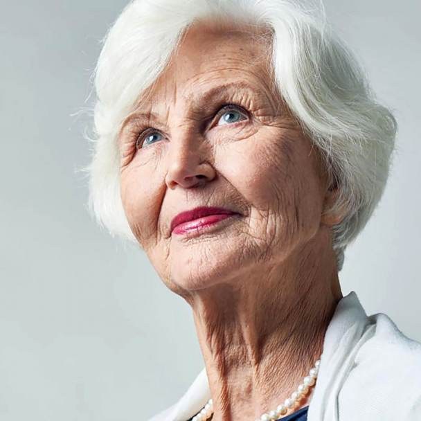 Rounded Bob with Glasses-Friendly Cheek Pieces — soft rounded bob hairstyle on a woman over 70 with gray hair