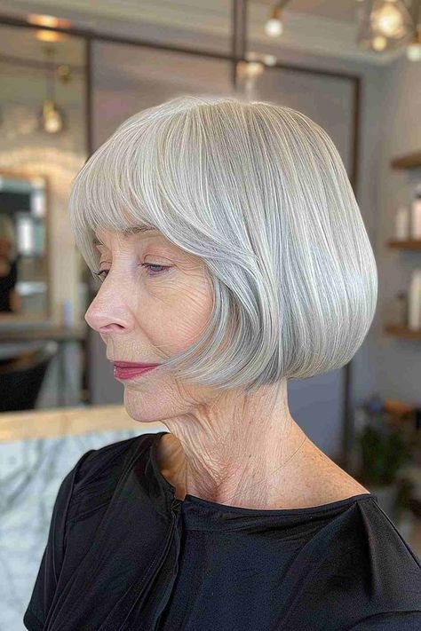 Rounded Lob with Gentle Curve — soft rounded bob hairstyle on a woman over 70 with gray hair