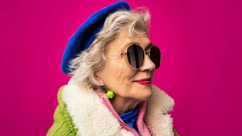 Beret and Sunglasses With a Curly Bob — stylish haircut on a fashion-loving woman over 70