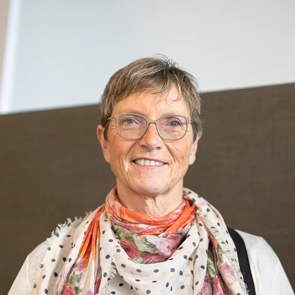 Short Crop With a Patterned Scarf and Glasses — stylish haircut on a fashion-loving woman over 70