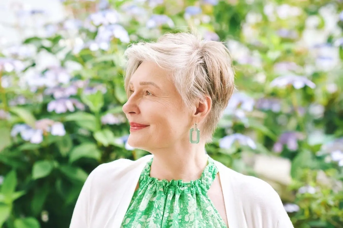 Woman over 70 with garden Pixie Among the Flowers — summer short haircut for women over 70
