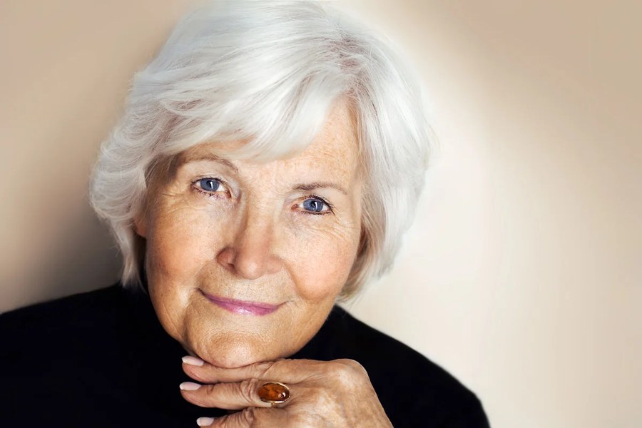 Woman over 70 with classic pageboy-inspired bob with a smooth finish — thin hair hairstyle for a woman over 70 that adds fullness