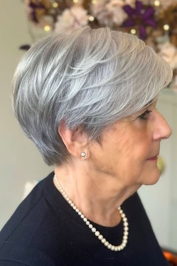 Woman over 70 with short bob with a shadow root effect — haircut for very fine hair on a woman over 70 that hides scalp show-through