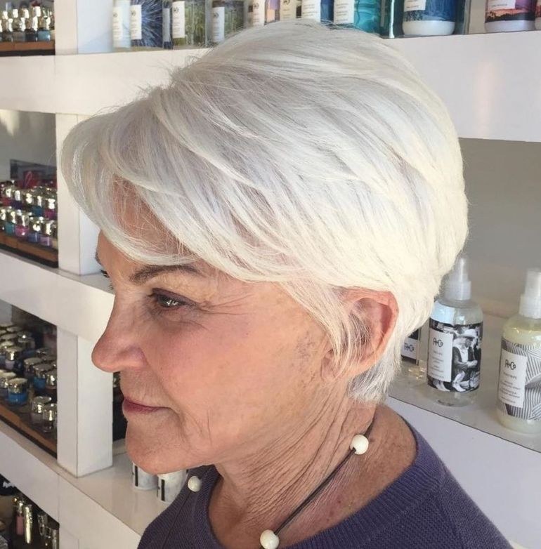 Woman over 70 with wispy full fringe with a chin-length cut — haircut for very fine hair on a woman over 70 that hides scalp show-through
