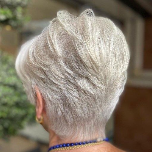 Woman over 70 with stacked crown pixie with forward layers — volumizing hairstyle for a woman over 70 with a thinning crown