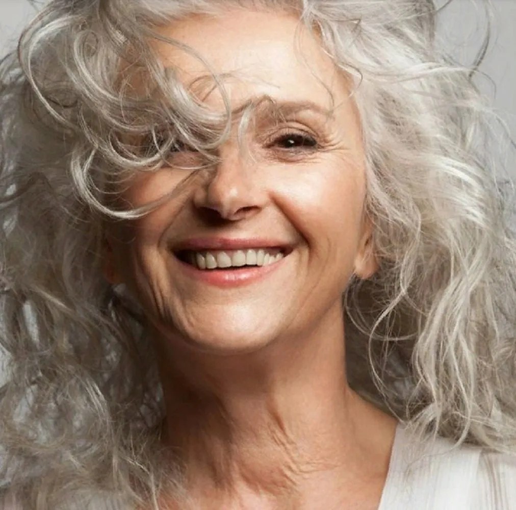 Windswept Long Waves, Joyfully Undone — wavy hairstyle on a woman over 70, soft and natural